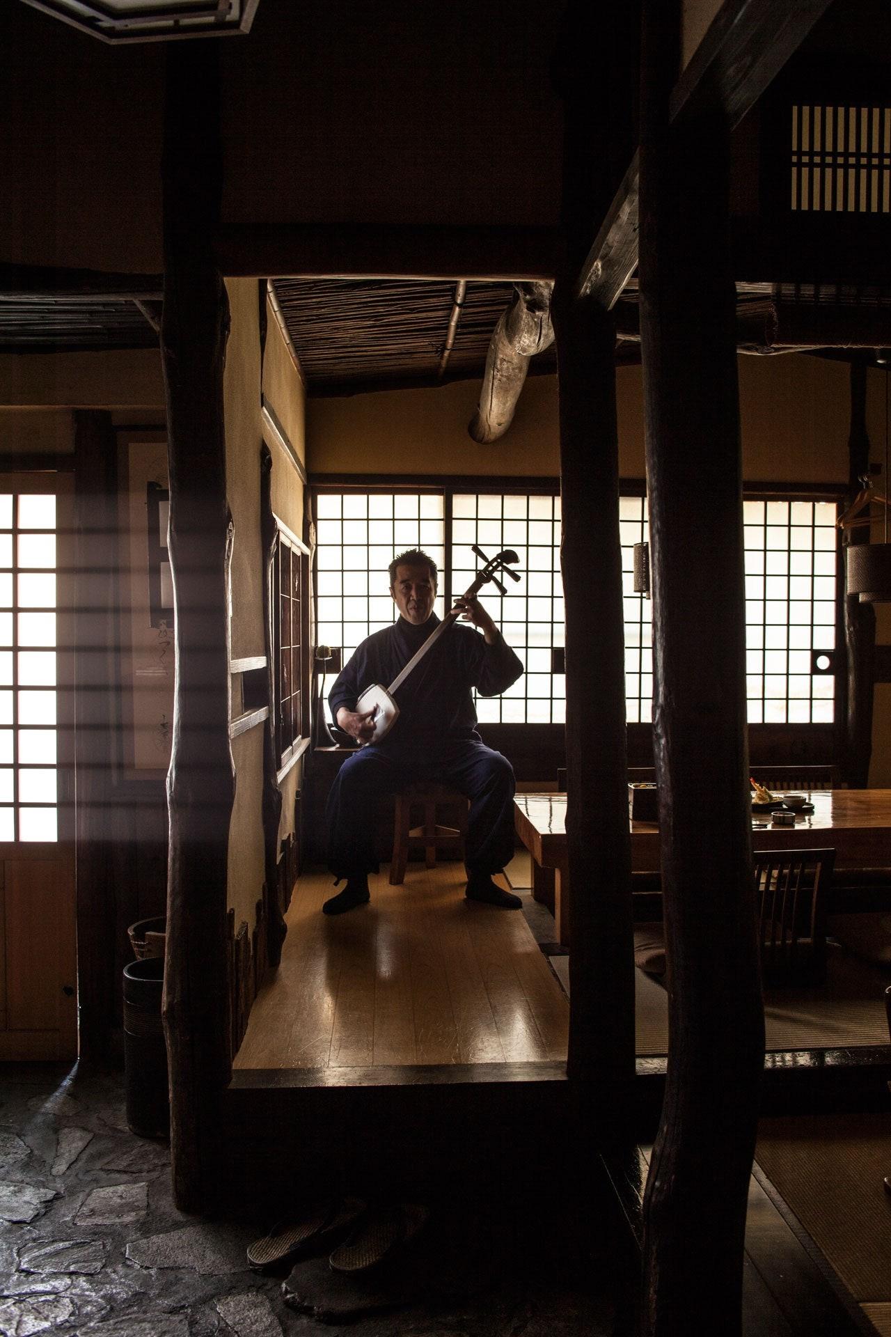 Kodai Fukui playing the tsugaru shamisen at his restaurant Waentei Kikko